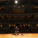 Couple getting engaged on stage at the New Amsterdam Theatre for Disney Aladdin on Broadway engagement package