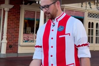 Disney Cast Member holding a baseball on Main Street U.S.A. at Walt Disney World