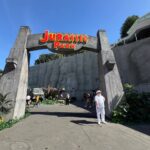 John Hammond face character at the Jurassic Park archway at Universal Studios Hollywood Journey Through the Eras