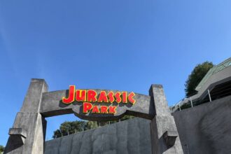 John Hammond face character at the Jurassic Park archway at Universal Studios Hollywood Journey Through the Eras