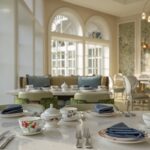 The reimagined Garden View Tea Lounge at Disneys Grand Floridian Resort featuring elegant table settings and Alice in Wonderland inspired decor
