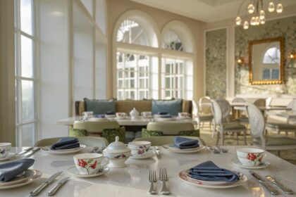 The reimagined Garden View Tea Lounge at Disneys Grand Floridian Resort featuring elegant table settings and Alice in Wonderland inspired decor