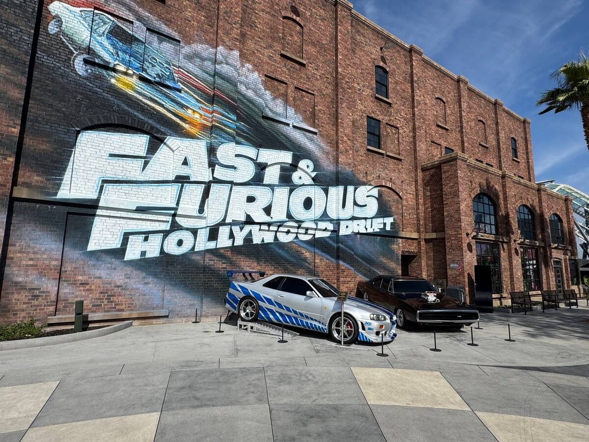 Brian's Nissan Skyline GT-R R34 and Dom's Dodge Charger R/T in front of the Fast & Furious: Hollywood Drift ride building at Universal Studios Hollywood