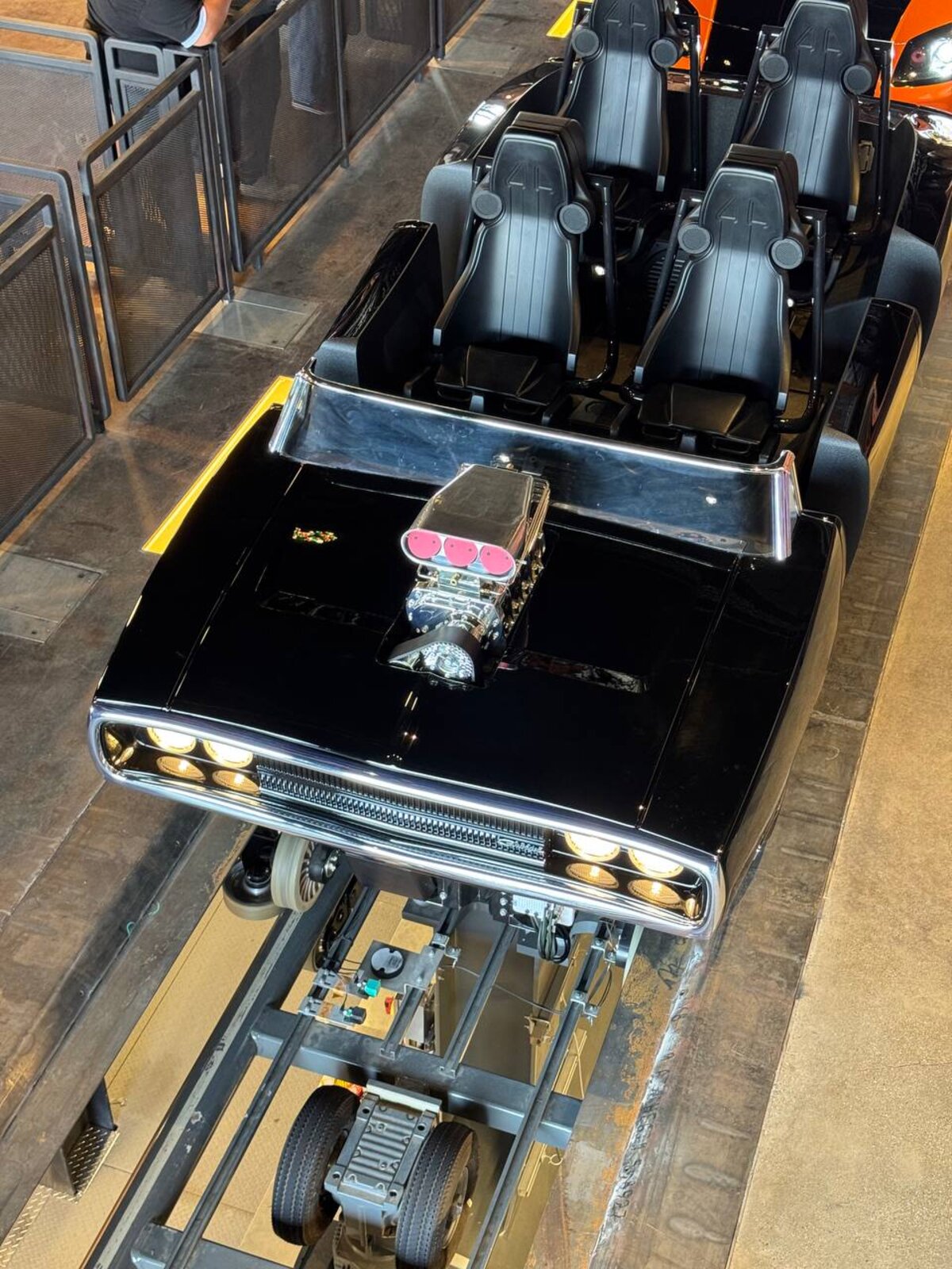 Dom's 1970 Dodge Charger R/T ride vehicle with headlights on at Fast & Furious: Hollywood Drift