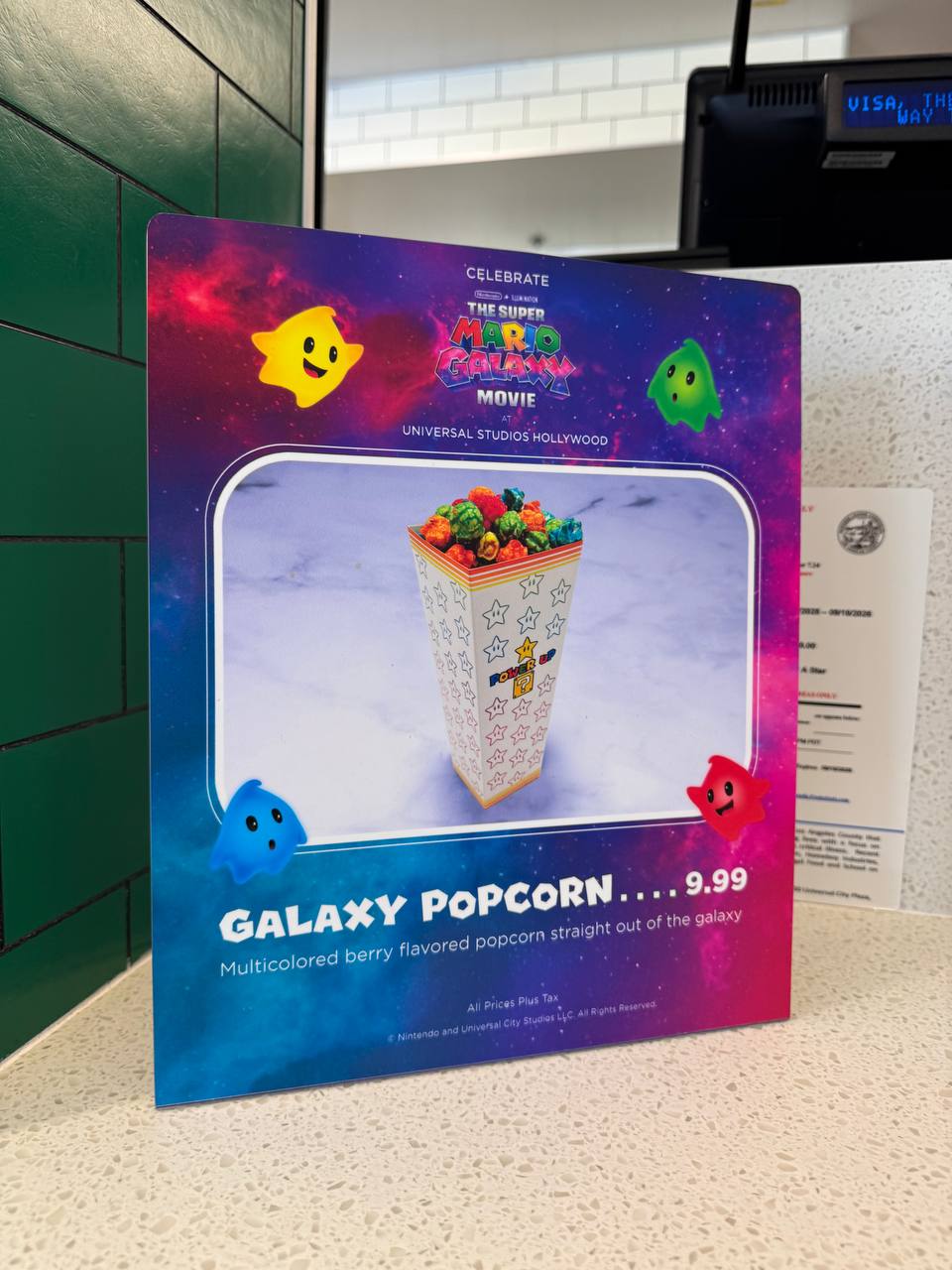 Galaxy Popcorn menu sign at Power Up Cafe showing $9.99 price