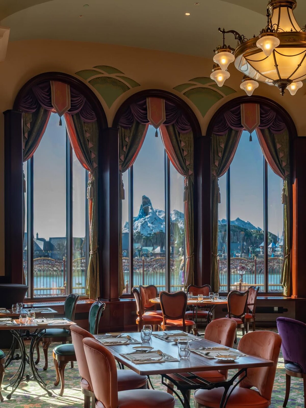 Interior of the Regal View Restaurant and Lounge featuring princess portraits and mural, Disney Adventure World