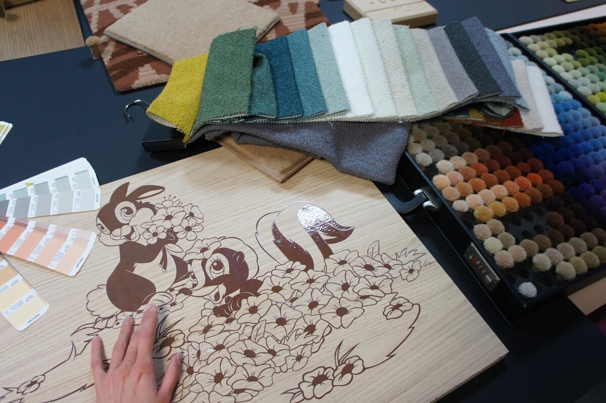 Bambi and Thumper illustration on a wooden design panel with Pantone swatches and fabric samples for Disney Sequoia Lodge rooms