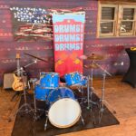 Animal drum kit display with Drums Drums Drums banner at Rock n Roller Coaster Starring The Muppets media preview