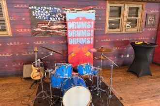Animal drum kit display with Drums Drums Drums banner at Rock n Roller Coaster Starring The Muppets media preview