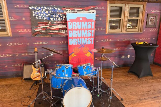 Animal drum kit display with Drums Drums Drums banner at Rock n Roller Coaster Starring The Muppets media preview