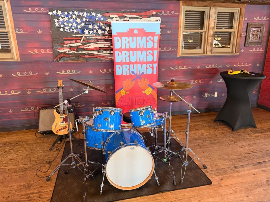 Animal drum kit display with Drums Drums Drums banner at Rock n Roller Coaster Starring The Muppets media preview