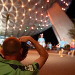 Disney PhotoPass cast member Dave Devore photographs runners during a runDisney race weekend at Walt Disney World