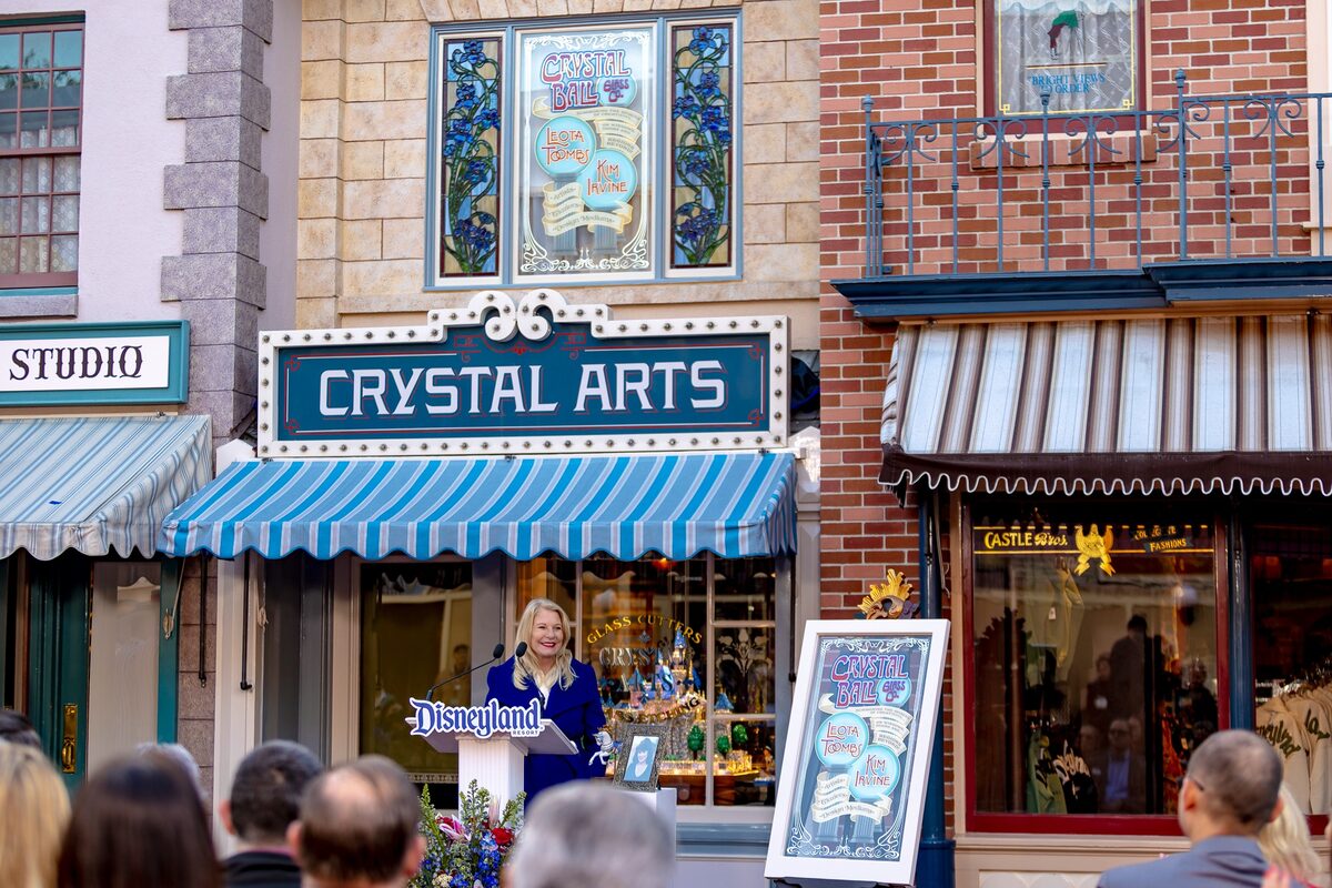 Kim Irvine speaks at Disneyland in front of Crystal Arts during the Main Street U.S.A. window dedication
