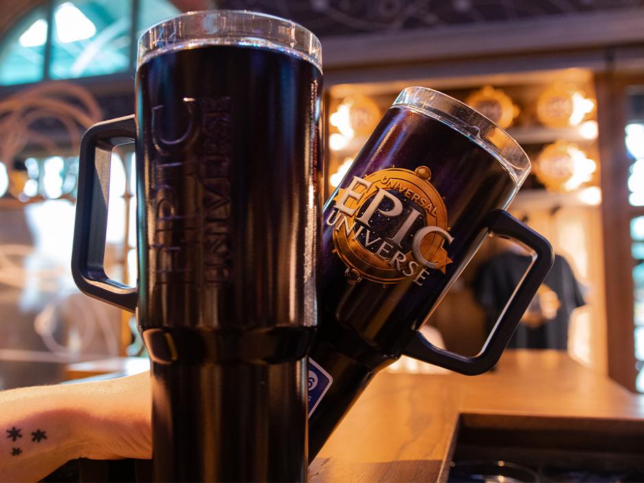 Universal Epic Universe tumblers and journals shown in Universal Orlando Resort's official merchandise guide