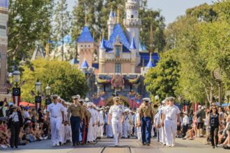 Service members march on Main Street, U.S.A. during Disneyland LA Fleet Week