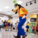 Goofy dances with Central Florida students during a Walt Disney World Cool KIDS SUMMER school visit.