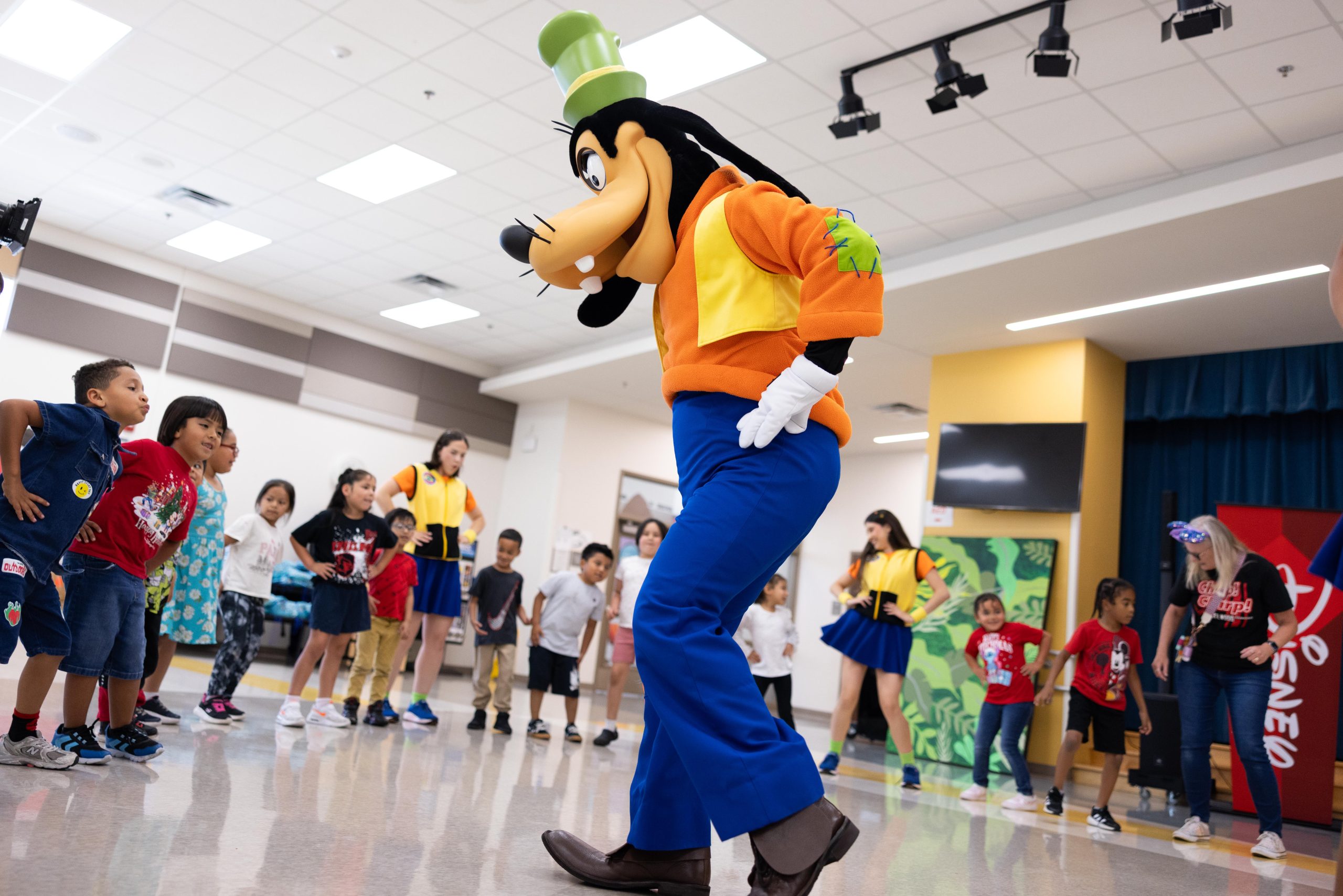 Goofy dances with Central Florida students during a Walt Disney World Cool KIDS SUMMER school visit.
