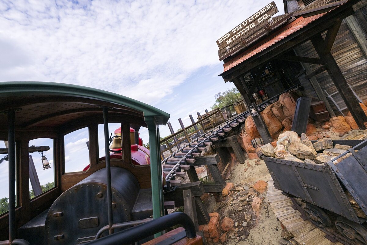 A Big Thunder Mountain Railroad train near the Big Thunder Mining Co. building at Magic Kingdom
