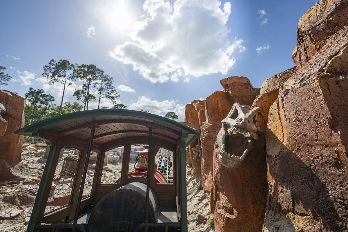 A refreshed Big Thunder Mountain Railroad train passing red rock scenery at Magic Kingdom