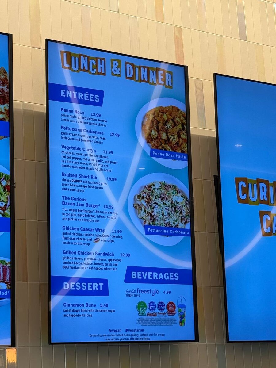 Curiosity Cafe lunch and dinner menu board with entrees, dessert, and beverages