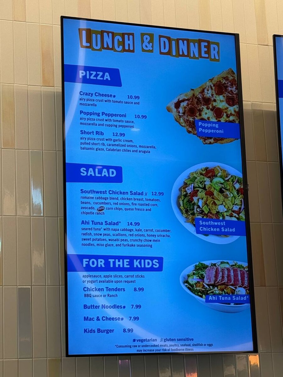 Curiosity Cafe lunch and dinner menu board with pizza, salad, and kids options