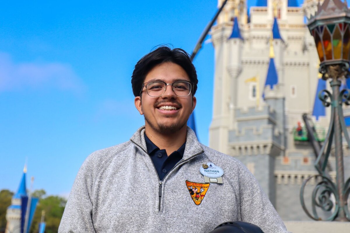FAM Associate Project Manager Nathan in front of Cinderella Castle