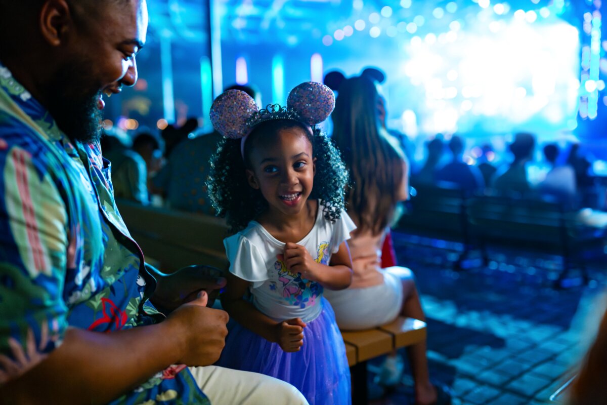 Family watching an Eat to the Beat concert at the EPCOT American Gardens Theatre