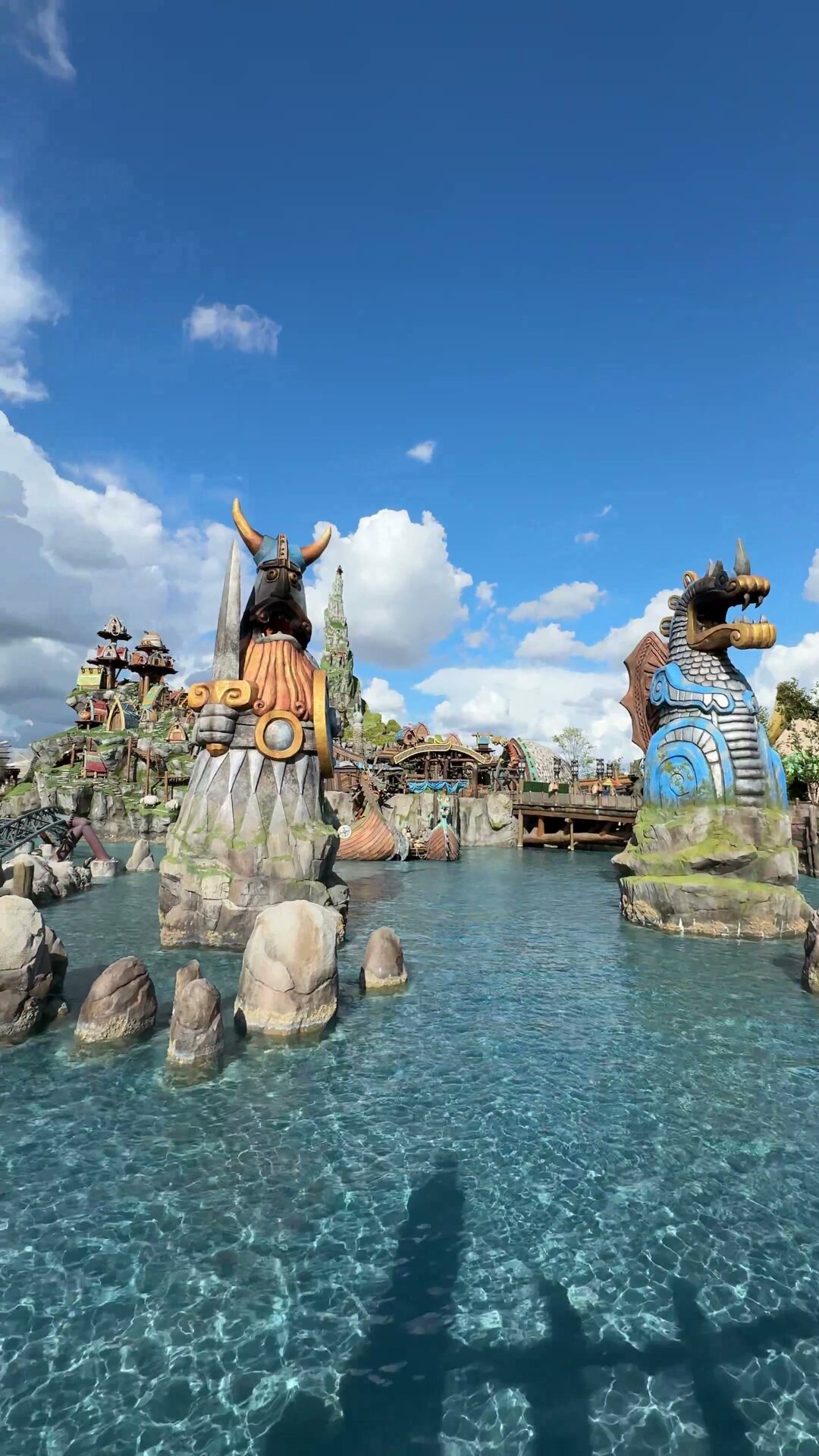 The Isle of Berk water and statues at Epic Universe