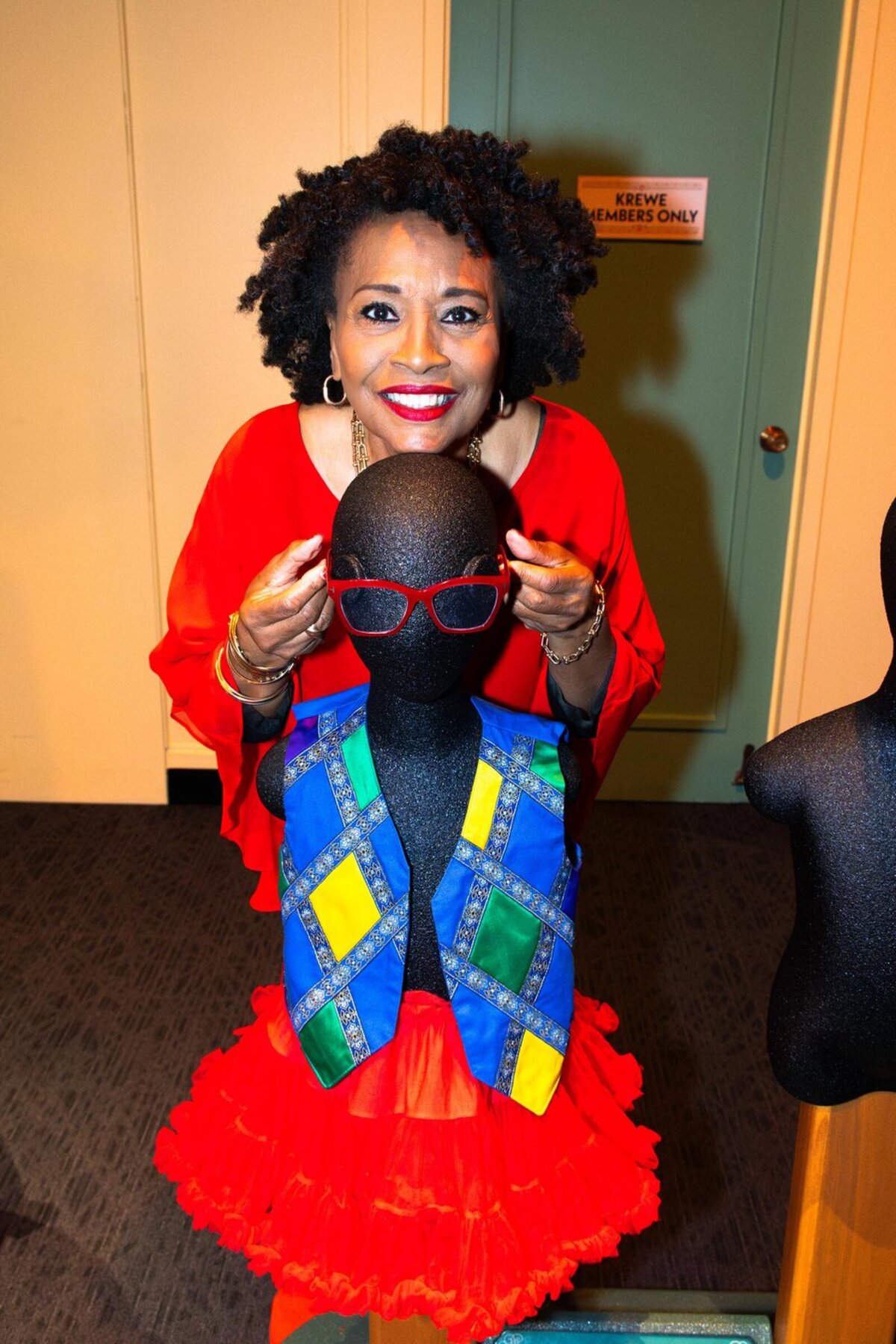 Jenifer Lewis poses with a costume element inside Tiana's Joyful Celebration. Photo credit: The Children's Museum of Indianapolis.