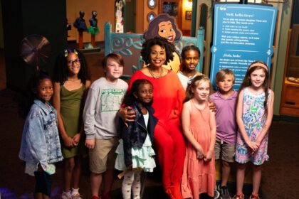 Jenifer Lewis with families inside Tiana's Joyful Celebration at The Children's Museum of Indianapolis. Photo credit: The Children's Museum of Indianapolis.