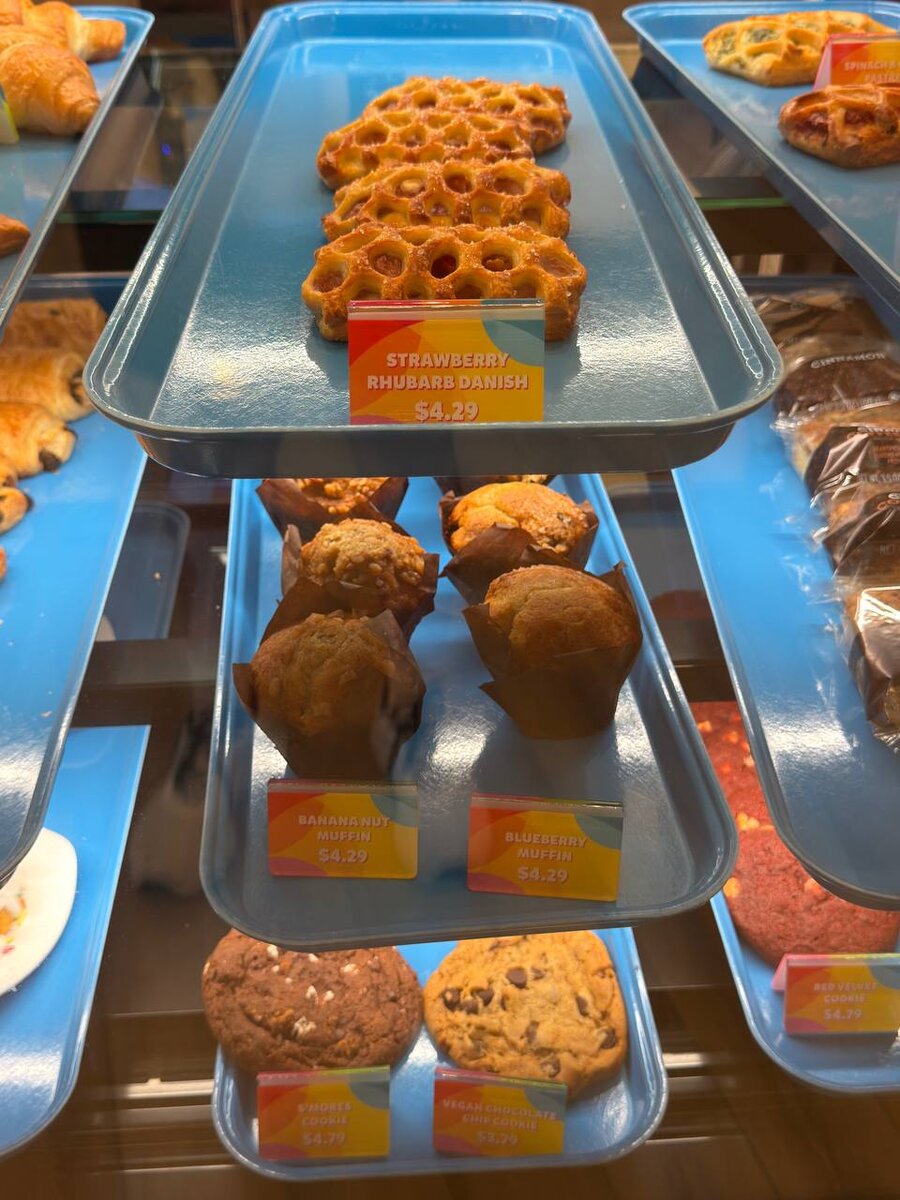 Bakery case with danish, muffins, and cookies at Curiosity Cafe