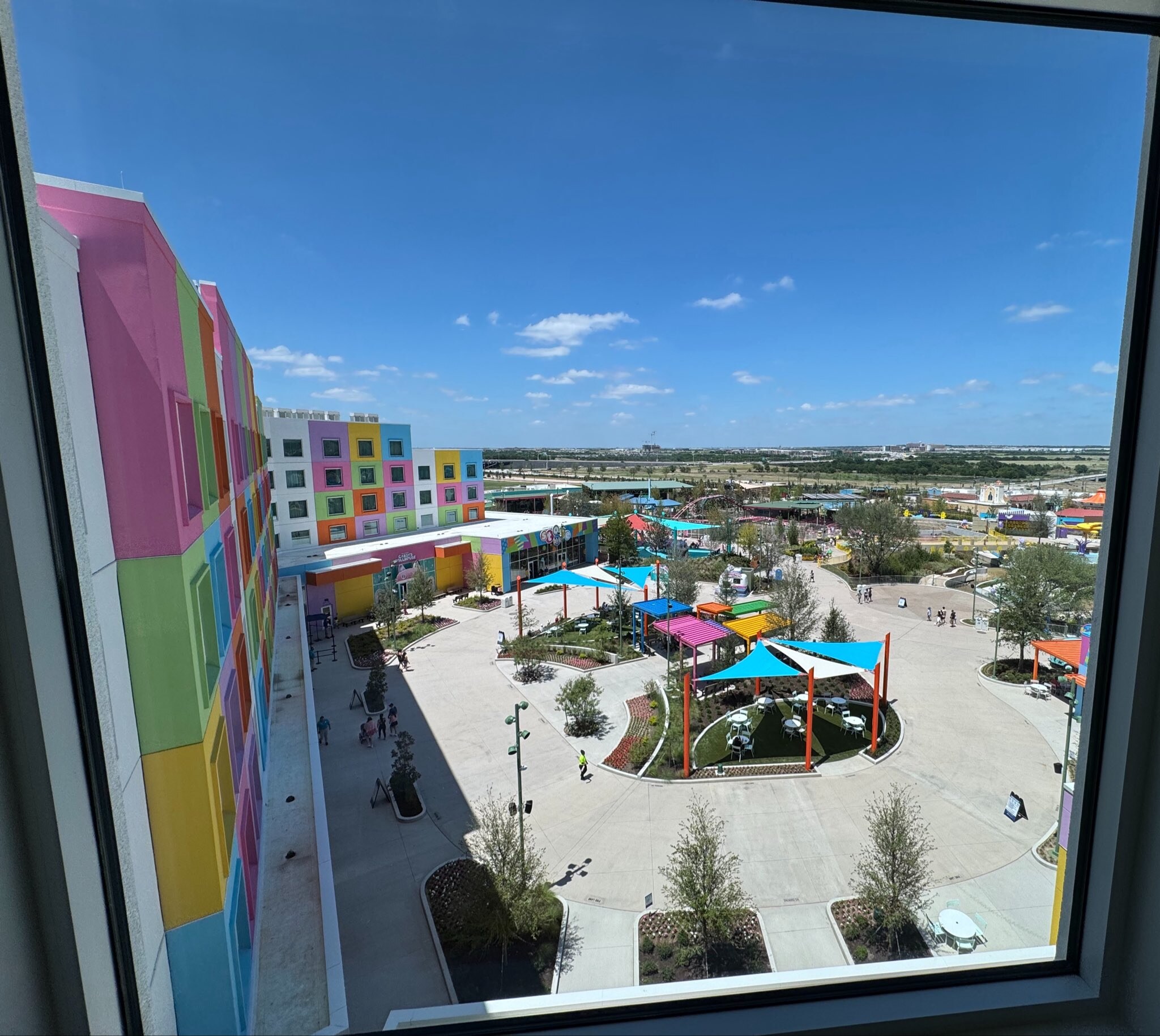 Theme park view of the colorful Universal Kids Resort buildings from a hotel room window