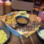 Roundup Rodeo BBQ all-you-care-to-enjoy skillet of house-smoked ribs, sausage, and brisket with sides at Disney's Hollywood Studios