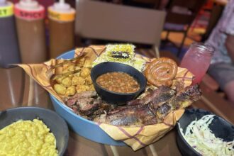 Roundup Rodeo BBQ all-you-care-to-enjoy skillet of house-smoked ribs, sausage, and brisket with sides at Disney's Hollywood Studios