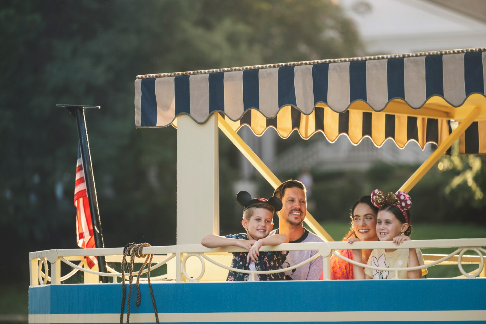 Family riding a Walt Disney World resort boat at sunset