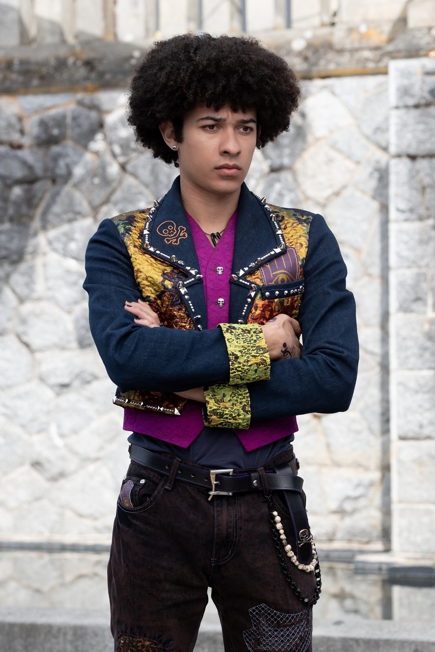 A Descendants: Wicked Wonderland character in a dark jacket with gold and purple details