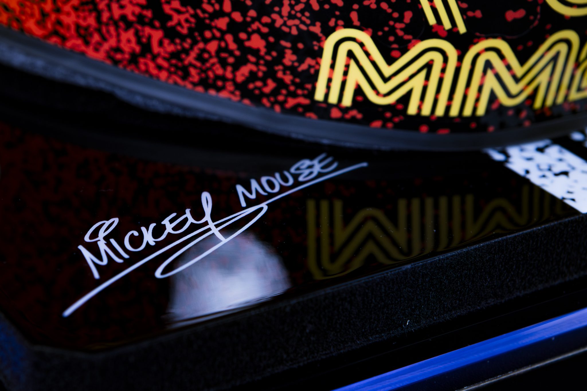 Mickey Mouse signature detail on the base of the Disney Formula 1 helmet display