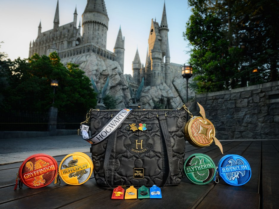 Lug Build-A-Bag Hogwarts bag with house coin purses and charms in front of Hogwarts castle