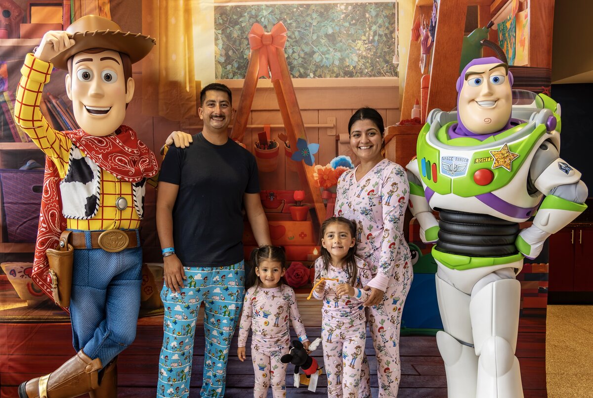 A military family meets Woody and Buzz Lightyear during Disney and Blue Star Families' Toy Story 5 event at Camp Pendleton.