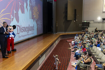 Josh D'Amaro and Mickey Mouse surprise Camp Pendleton military families with Disneyland Resort tickets during a Toy Story 5 screening.
