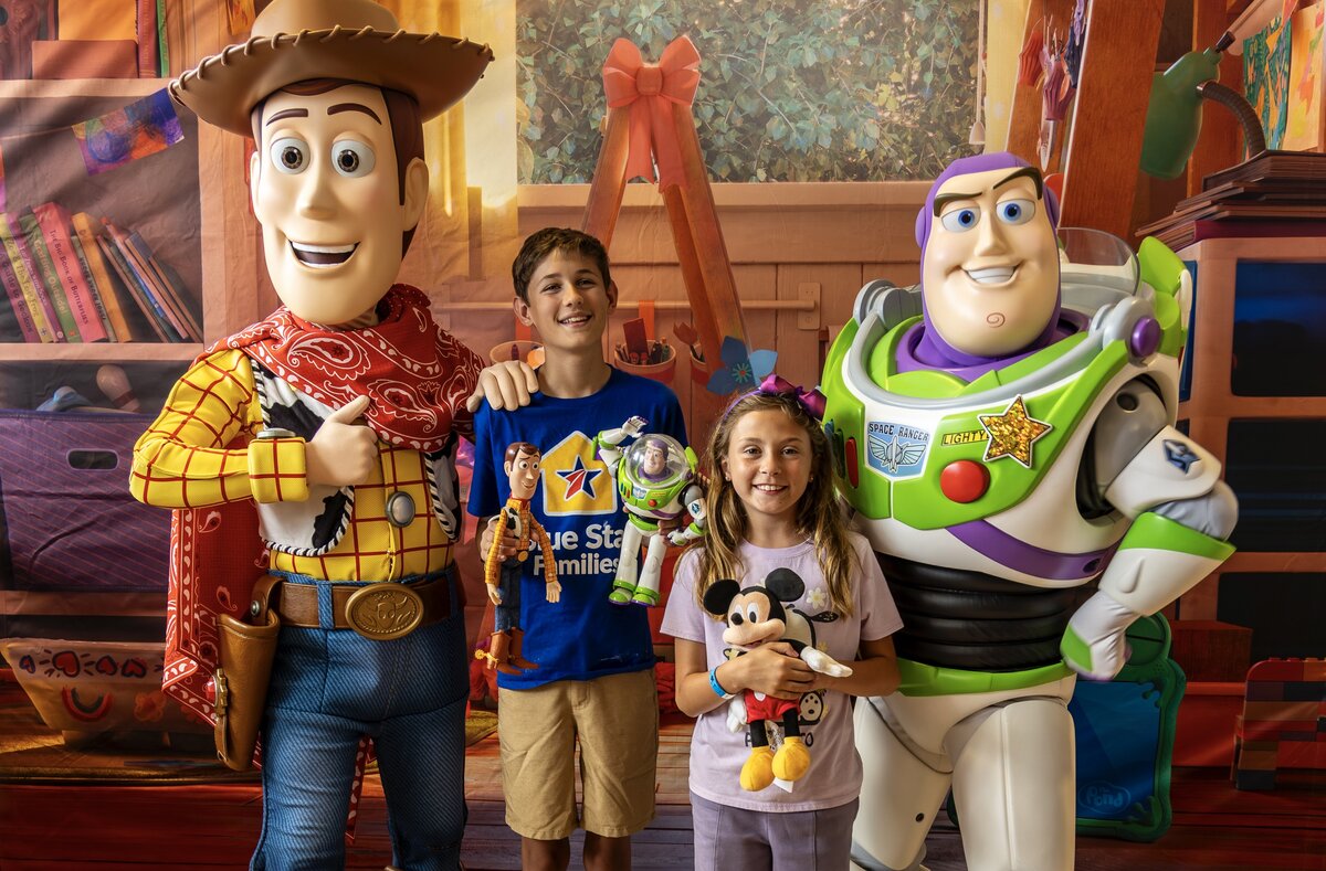 Woody and Buzz Lightyear pose with military children at the Camp Pendleton Toy Story 5 screening.