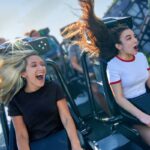 Two riders reacting on a roller coaster at Universal Orlando Resort