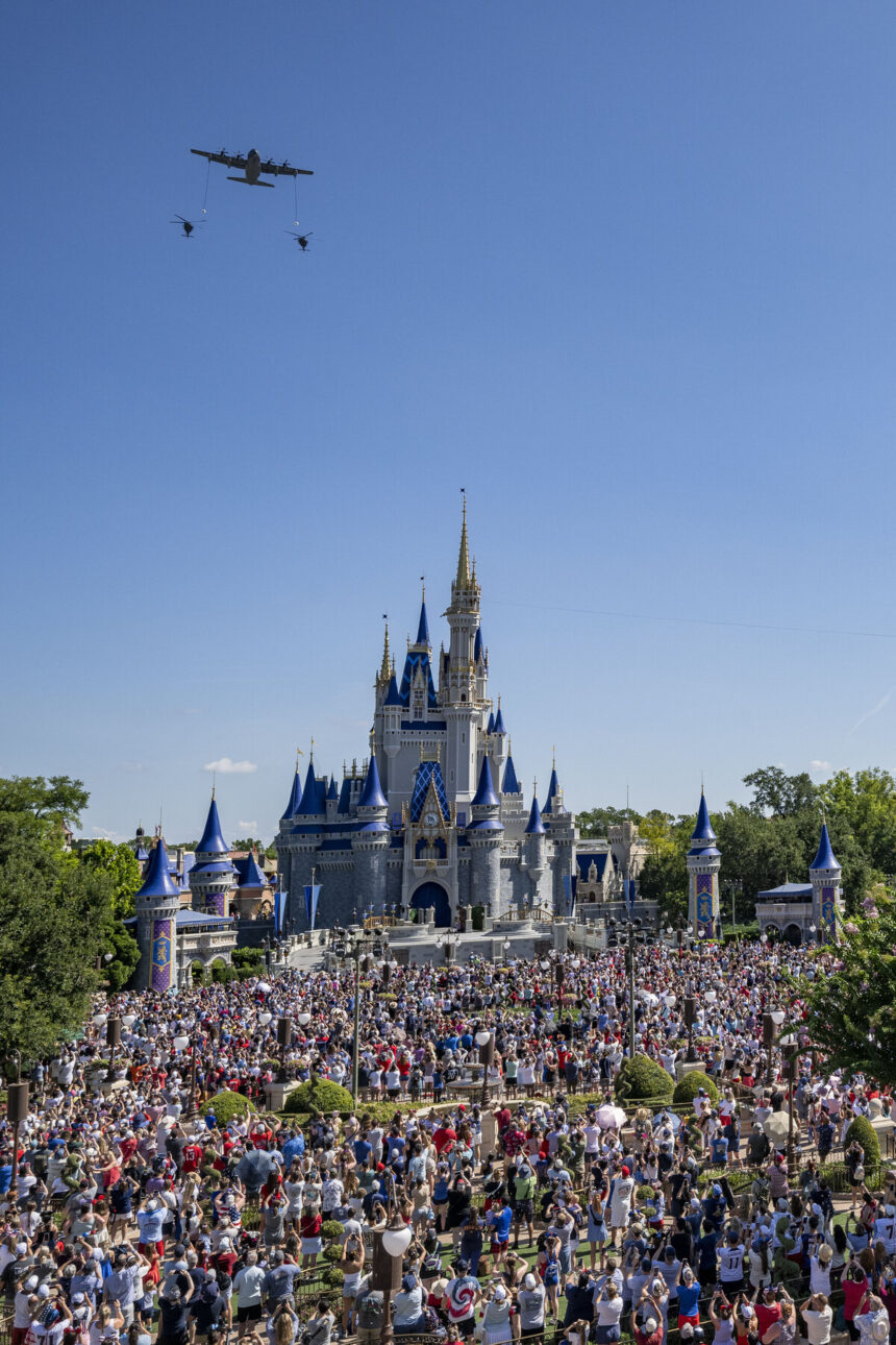 U.S. Air Force aircraft fly over Cinderella Castle at Magic Kingdom as crowds watch during Walt Disney World's July 4 2026 flyover