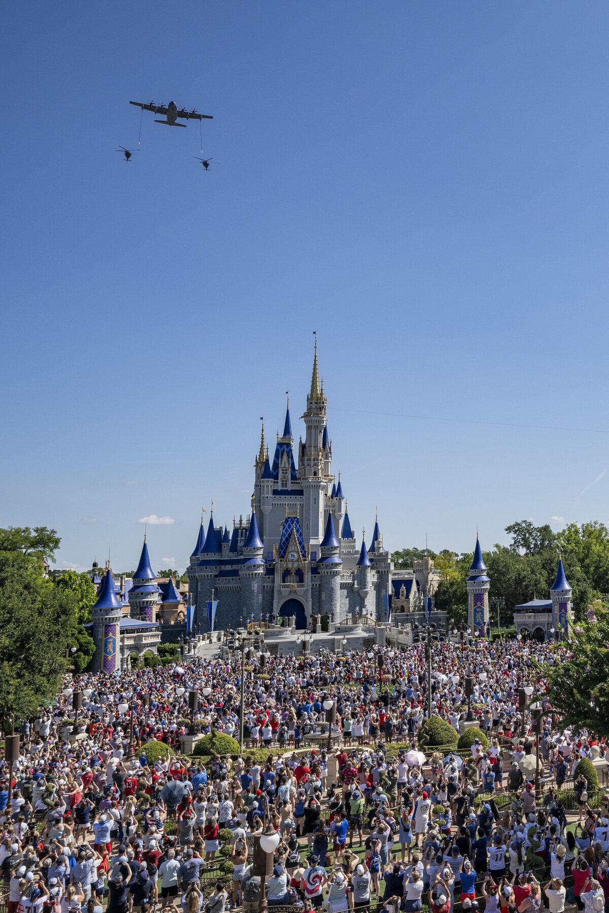 U.S. Air Force aircraft fly over Cinderella Castle at Magic Kingdom as crowds watch during Walt Disney World's July 4 2026 flyover