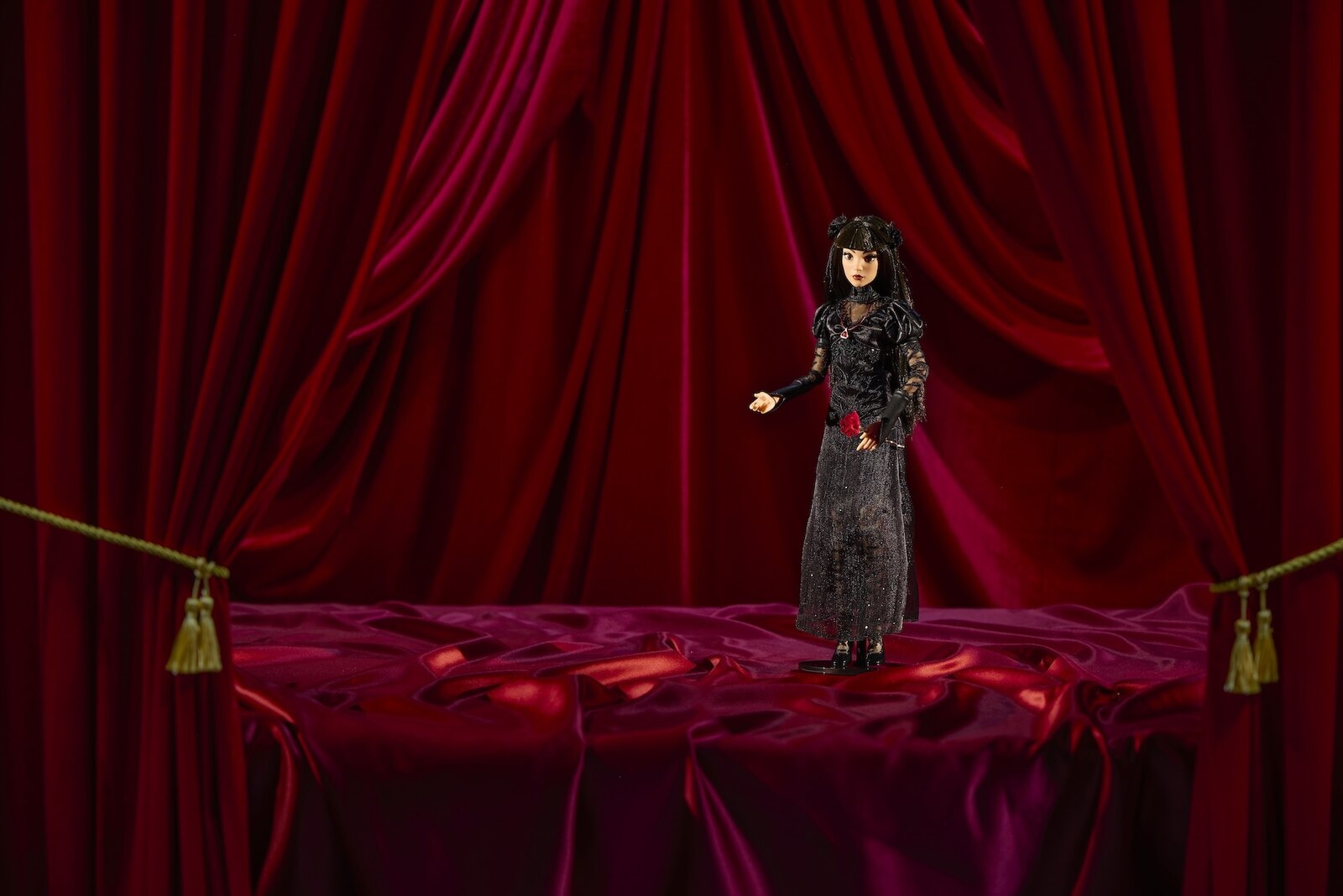 Werecat Lady doll standing upright on its included display stand against red curtains