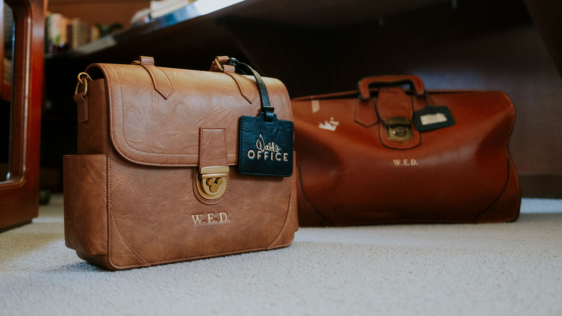 Leather bags with W.E.D. monogram from the Walt's Office collection, inspired by Walt Disney's travel bag