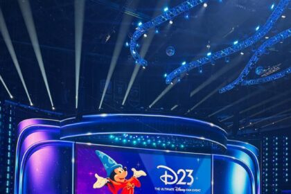 The Disney Entertainment Showcase stage at Honda Center with Sorcerer Mickey on the screen for D23 2026