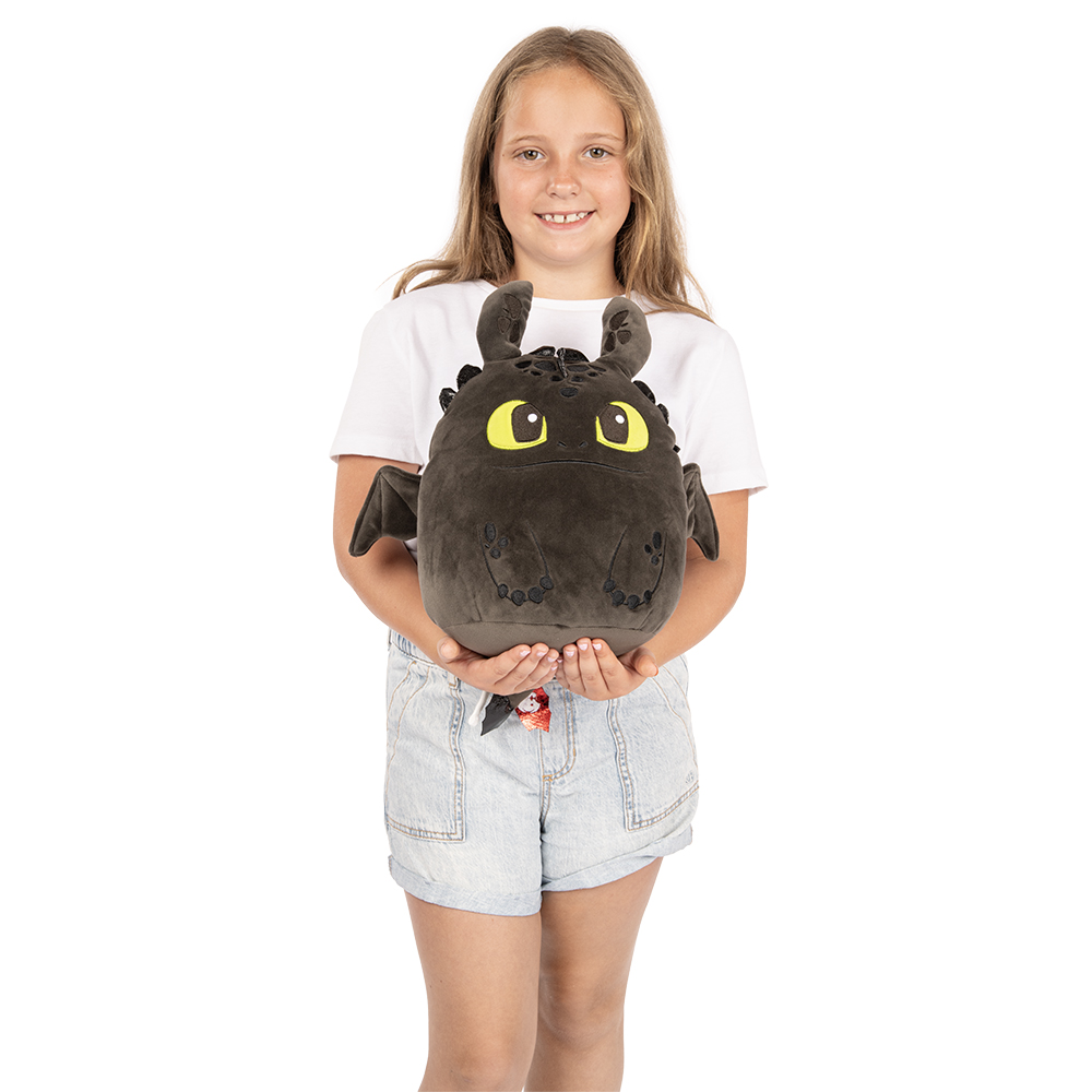 Model holding the Toothless How to Train Your Dragon Squishmallow