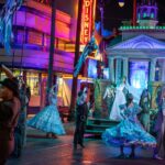 Performers in blue period costumes dance at Madame Leota's Swinging Wake at Disney California Adventure Park