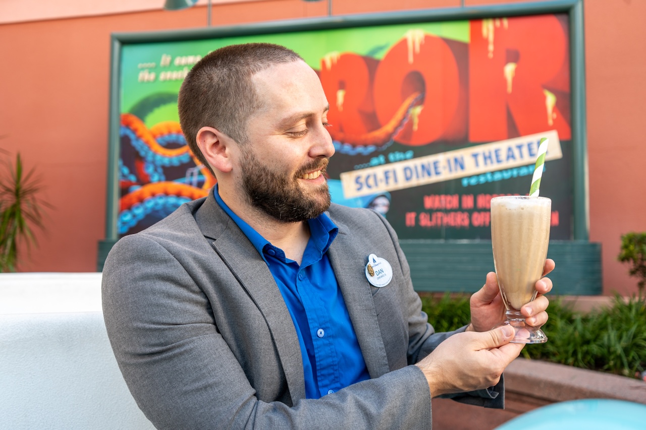 Dan holding a milkshake.